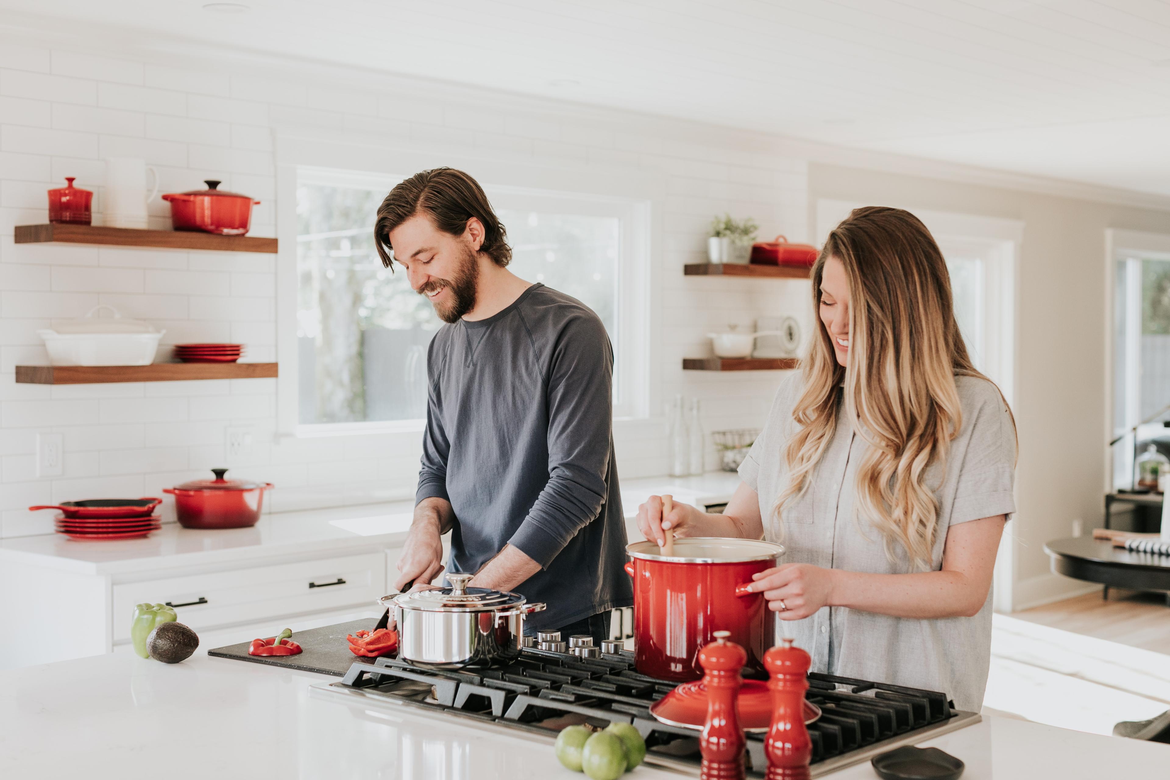 Male and female cooking dinner