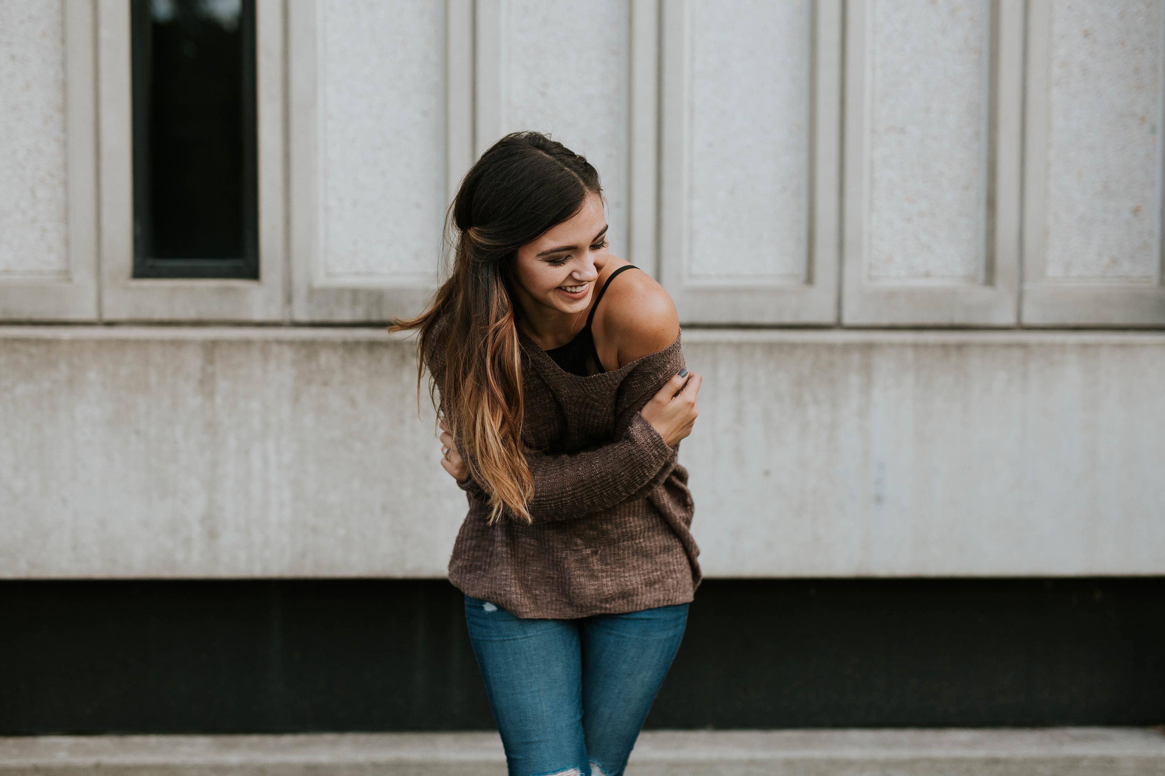 Woman laughing with her legs crossed